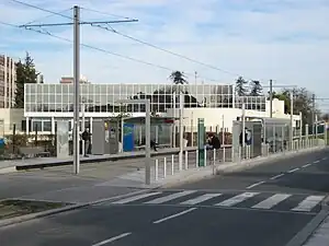 Double-track railway line in street with shelters on side platforms