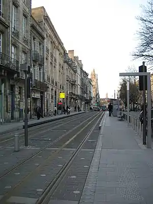 Side platforms next to double-track railway line in the street