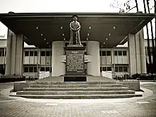 Statue of Lee Kong Chian, a major donor, after whom the Kong Chian Administration Centre in the background is named