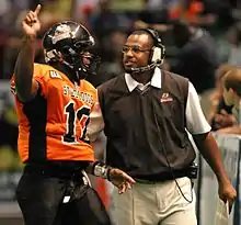 Quarterback Jeff Aaron talks strategy with Head Coach Bobby Humphrey