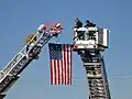 Tower 602 & Truck 690 perform a flag arch