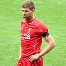 Gerrard with his hands on his hips looking concerned