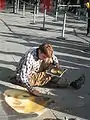 A street painter working near the Centre Pompidou, Paris. The painting being copied is Vermeer's Girl with a Pearl Earring.