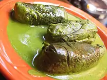 Stuffed grape leaves with yogurt mint sauce