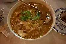 A soup of suan cai stewed with pork and cellophane noodles. It is a very common dish in Northeastern China.