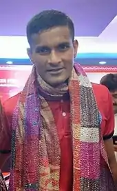 Portrait of Subrata Pal wearing a colourful shawl.