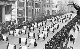 Women's suffragists parade in New York City in 1917, carrying placards with signatures of more than a million women.