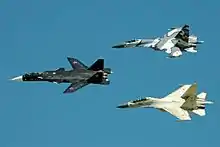 Sukhoi Su-47 Berkut in the lead, followed by a Su-27SKM (top) and a Su-30MKK (bottom).