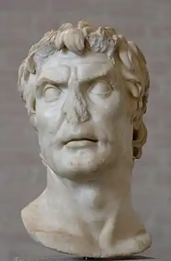 Photograph of a marble bust of a man, with its nose broken off.