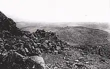 View of rocky ground and cultivated terraces in landscape extending to the horizon