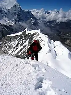 Image 3A climber taking the final few steps to the 6,160 m (20,210 ft) summit of Imja Tse (Island Peak) in Nepal, 2004 (from Mountaineering)