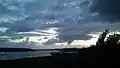 Sunset, windy weather and rainclouds across the lake.