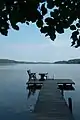 A typical Finnish pier with a table, chair and ladders for swimmers in Joutsa, Central Finland