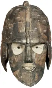 Colour photograph, taken from the front against a white background, of the first reconstruction of the Sutton hoo helmet