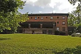 The orange brick façade of the Telluride House as seen from West Ave