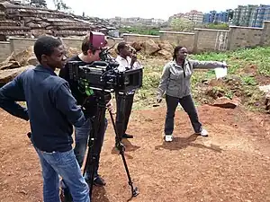 Image 10Filmmaker Nathan Collett (with camera) shooting feature film Togetherness Supreme in collaboration with Kibera youth trainees. (from Culture of Kenya)