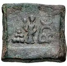 Taxila single-die coin with Lakshmi and arched-hill symbol (185-160 BCE).