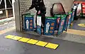 Portable tactile mat being used to block off an escalator under maintenance