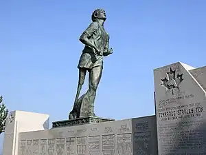 Statue of a runner with an artificial leg looking skyward.