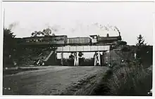 a steam train crossing an old bridge