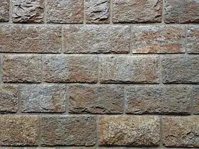 A wall of bricks with raised areas