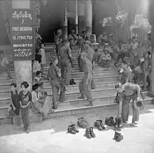 Image 11British soldiers remove their shoes at the entrance of Shwedagon Pagoda. To the left, a sign reads "Foot wearing is strictly prohibited" in Burmese, English, Tamil, and Urdu. (from Culture of Myanmar)