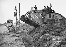 British Mark V tank (B56, 9003) of the 2 Battalion, Tank Corps traversing a ditch at the side of a road at Lamotte-en-Santerre, 8 August 1918.