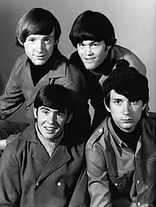 A photograph of each of the Monkees: Peter Tork, Micky Dolenz, Michael Nesmith and Davy Jones