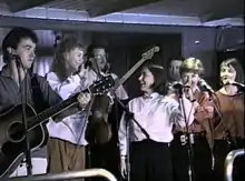 The Rankin Family performing aboard the M/S Scotia Prince, April 18, 1990. From left to right: Jimmy Rankin, Natalie MacMaster, Bruce Phillips, Raylene Rankin, John Morris Rankin, Cookie Rankin, Heather Rankin.