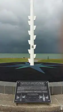 Totem-style pole against an angry coastal sky.