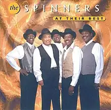 The group posing together in hats and vests