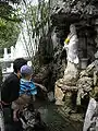 Small fountain with Guanyin dispensing water from her jar.