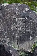 Anthropomorphic figure decorated with abstract designs.