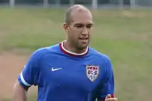 Top half of a male athlete who appears to be running