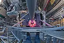 The Times Square Ball, a multicolored ball, as seen from the roof of One Times Square in 2012. Traffic at street level is visible in the background.