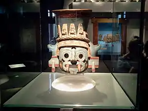 Tlāloc effigy vessel; 1440–1469; painted earthenware; height: 35 cm (13⁄4 in.); Museo del Templo Mayor (Mexico City). Templo Mayor, dedicated to Tlāloc. This jar, covered with stucco and painted blue, is adorned with the visage of Tlāloc, identified by his coloration, ringed teeth and jaguar teeth