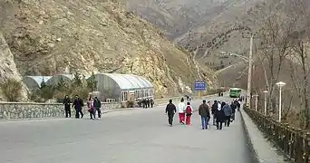 Pedestrians near the entrance to the complex.