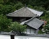 Wooden building with pyramid shaped roof.