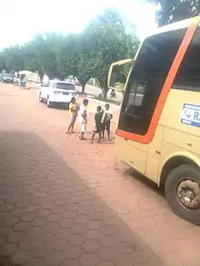 Children standing in front of a bus