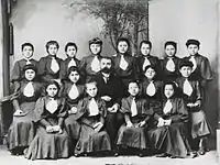 Rows of Pontian girls in school uniforms with their teacher.