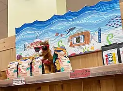 A stuffed animal mascot at a Trader Joe's store