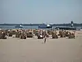 Excursion boats and roofed wicker beach chairs