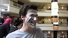 Man cosplaying as Trollface