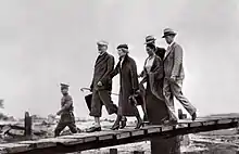 Leon Trostky and his wife arriving in Mexico with Kahlo walking behind them.