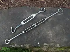 Top: lower quality aluminum bolt and hook turnbuckle; bottom: higher quality cast stainless steel turnbuckle