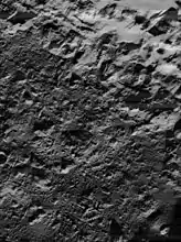 Lunar Orbiter 5 image of the northeastern crater floor, showing irregular surface of cracked impact melt.  Illumination is from lower right.