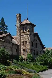 Romanesque stone building surrounded by shrubs