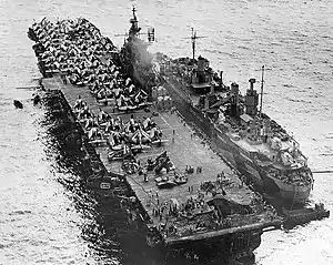 USS Randolph (CV-15) under repair at Ulithi from USS Jason on 13 March 1945 after flight deck hit by kamikaze