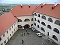 An interior courtyard of the castle, seen with modern roofs.