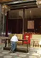 A churchgoer prays in front of the Holy Shroud